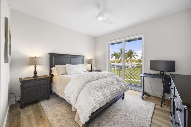 bedroom with light wood-type flooring, access to outside, and a ceiling fan