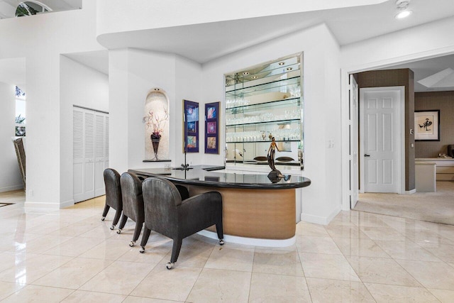 bar with baseboards and indoor wet bar