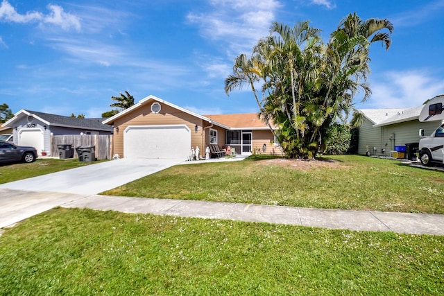 ranch-style home featuring driveway, a garage, fence, and a front lawn