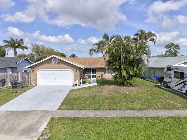 ranch-style house with a garage, fence, concrete driveway, and a front yard