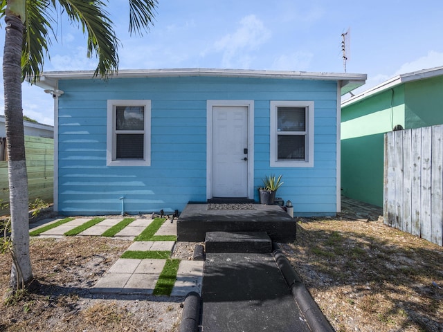 bungalow-style home with fence