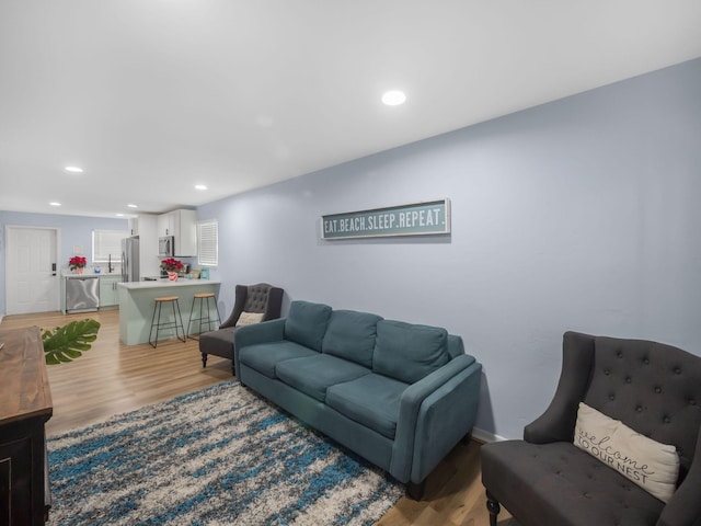 living room featuring light wood finished floors and recessed lighting