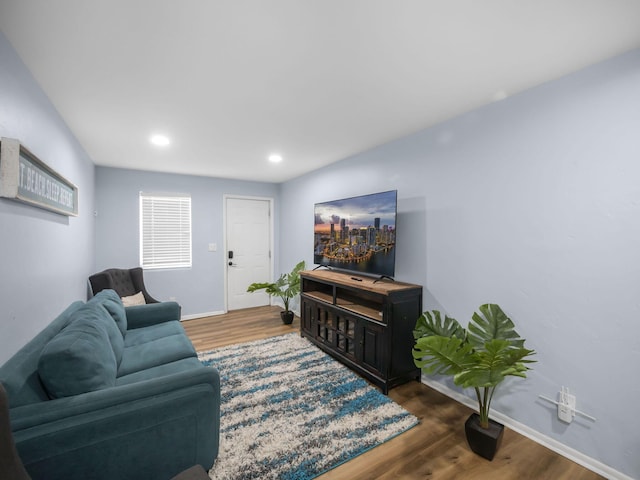 living room with recessed lighting, baseboards, and wood finished floors