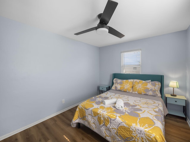 bedroom with wood finished floors, a ceiling fan, and baseboards