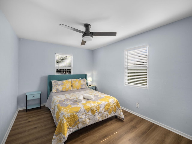 bedroom with ceiling fan, baseboards, and wood finished floors