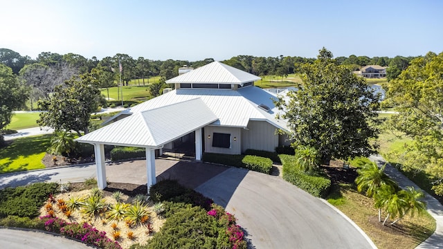 view of front of property with metal roof, a carport, a standing seam roof, and concrete driveway