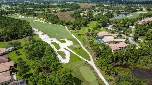 birds eye view of property with golf course view, a water view, and a residential view