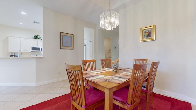 dining room featuring a notable chandelier, light tile patterned floors, recessed lighting, visible vents, and baseboards