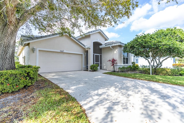 single story home with an attached garage, driveway, and stucco siding