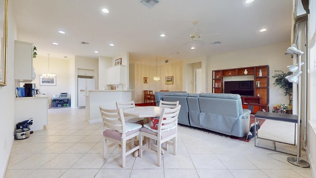 dining space featuring light tile patterned floors, ceiling fan with notable chandelier, visible vents, and recessed lighting