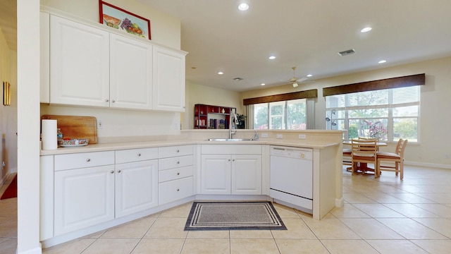 kitchen with recessed lighting, light tile patterned flooring, a sink, dishwasher, and a peninsula