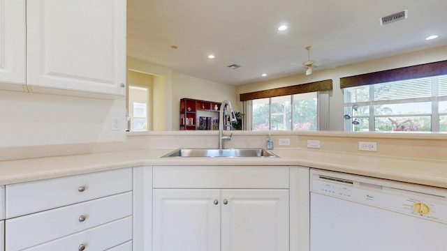 kitchen featuring white dishwasher, recessed lighting, a sink, visible vents, and white cabinetry