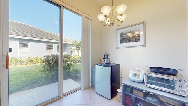 doorway to outside with light tile patterned floors and a chandelier