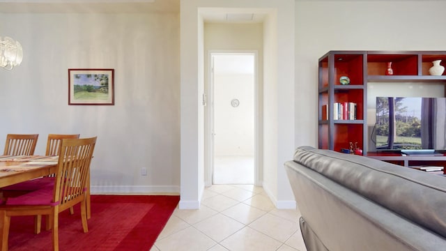 dining space with light tile patterned floors and baseboards