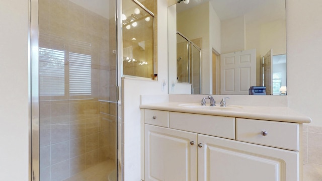 bathroom with a shower stall and vanity