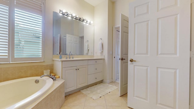 bathroom with vanity, tile patterned flooring, and a bath