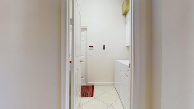 laundry room featuring laundry area, washer and clothes dryer, baseboards, and light tile patterned floors