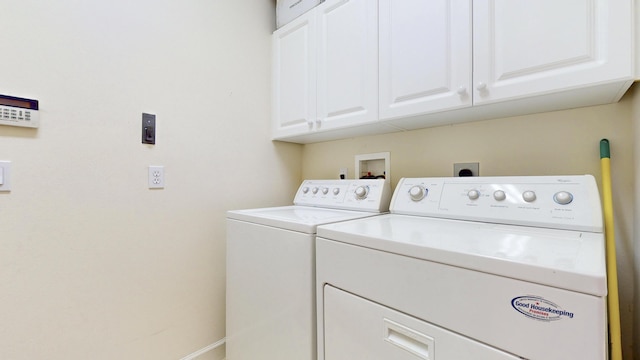 laundry room with cabinet space and separate washer and dryer