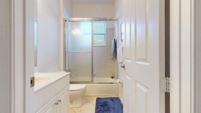 full bathroom featuring toilet, shower / bath combination with glass door, vanity, and tile patterned floors