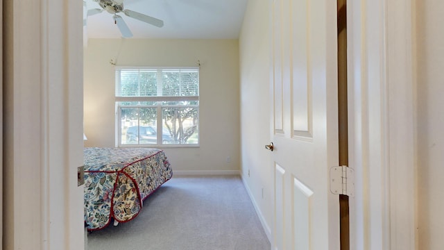 bedroom with carpet, a ceiling fan, and baseboards