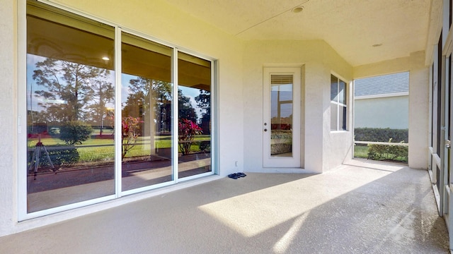 property entrance featuring a patio area and stucco siding