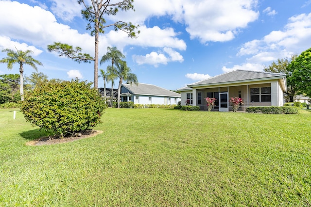 view of yard featuring a sunroom