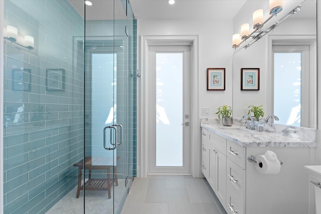 full bath featuring a stall shower, tile patterned flooring, and vanity