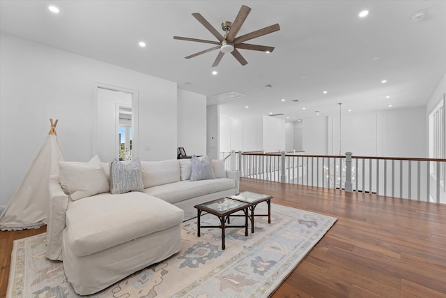 living room with a ceiling fan, hardwood / wood-style flooring, and recessed lighting