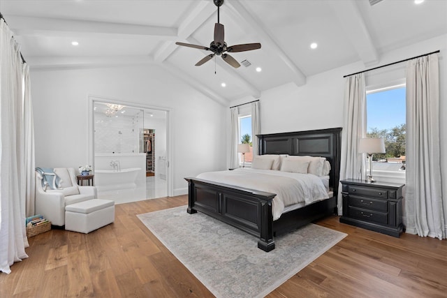 bedroom with multiple windows, ceiling fan, lofted ceiling with beams, and wood finished floors