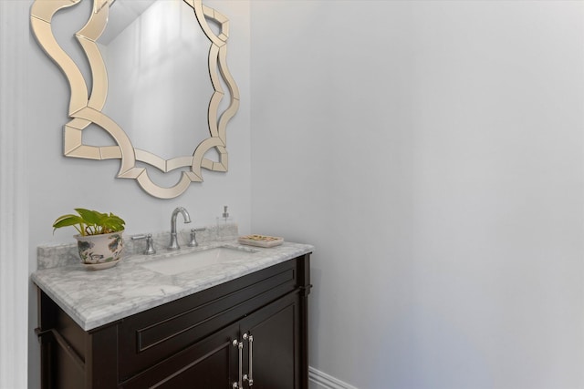 bathroom featuring baseboards and vanity