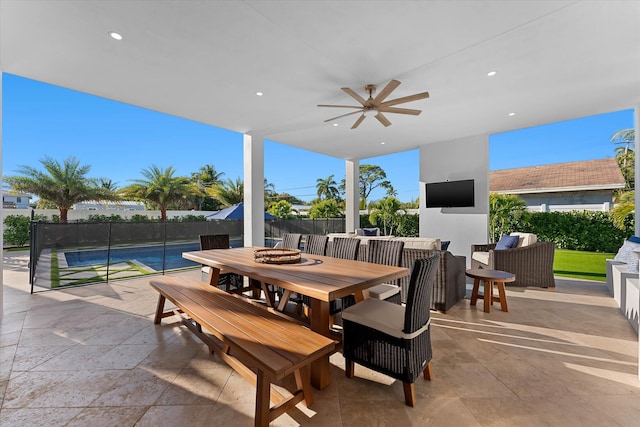 view of patio / terrace featuring outdoor dining area, fence, a ceiling fan, and a fenced in pool