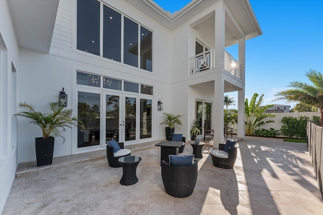 back of house featuring a patio, french doors, fence, and a balcony