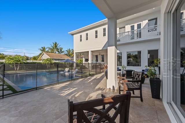 view of swimming pool with a patio, outdoor dining area, and a fenced in pool