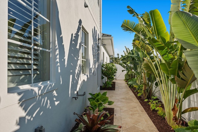 view of property exterior with fence and stucco siding