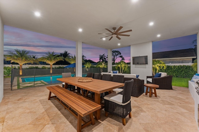 patio terrace at dusk with a fenced in pool, outdoor dining area, outdoor lounge area, fence, and ceiling fan