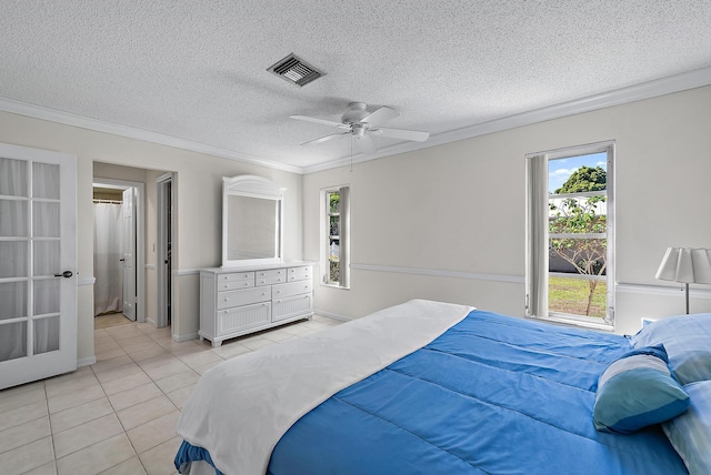 bedroom featuring a textured ceiling, light tile patterned flooring, visible vents, and ornamental molding