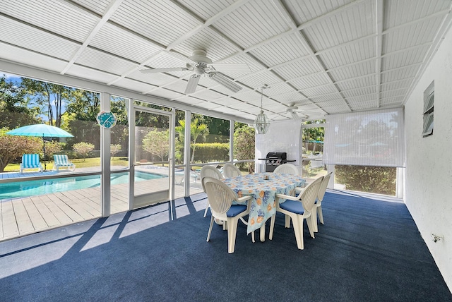 sunroom / solarium with a ceiling fan