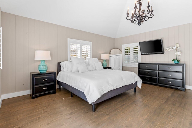 bedroom with lofted ceiling, multiple windows, and dark wood finished floors