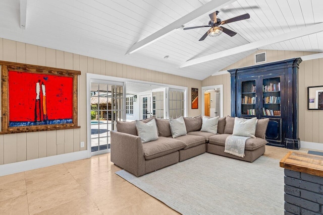 living room featuring visible vents, wooden walls, vaulted ceiling with beams, baseboards, and a ceiling fan