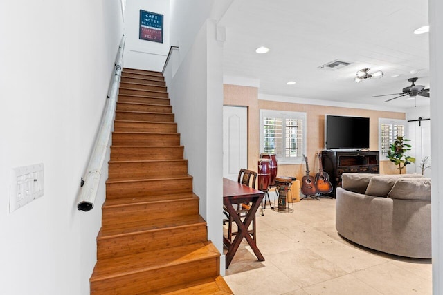 stairway with ceiling fan, ornamental molding, visible vents, and recessed lighting