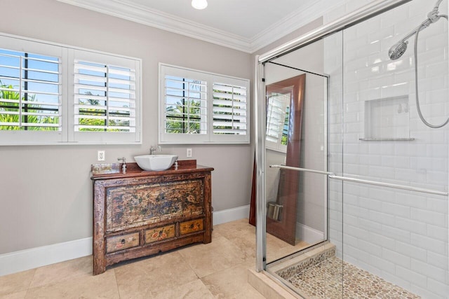 bathroom with a stall shower, tile patterned flooring, crown molding, and vanity