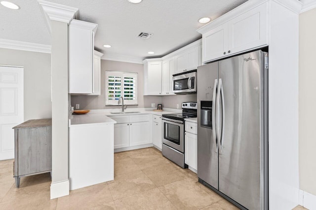 kitchen with visible vents, stainless steel appliances, crown molding, white cabinetry, and a sink