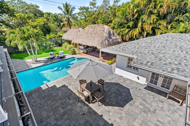 view of pool featuring outdoor dining area, a fenced backyard, a yard, a fenced in pool, and a patio area