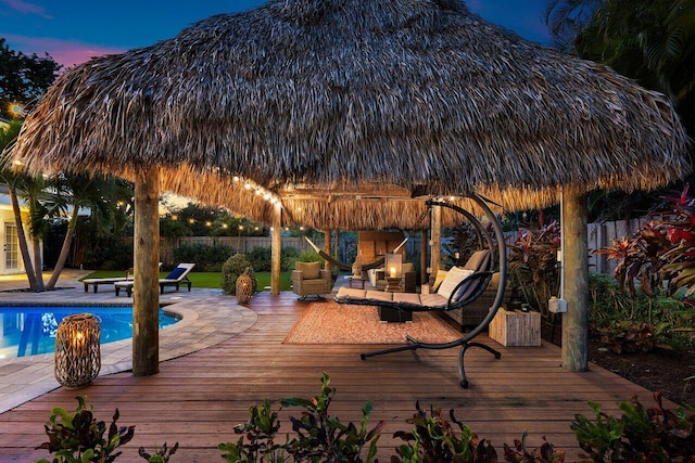 deck featuring a fenced in pool, fence, and a gazebo