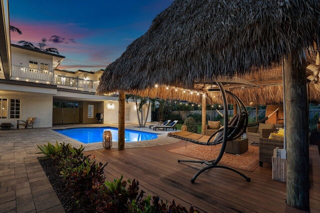 pool at dusk featuring fence and a fenced in pool