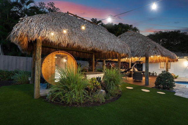 view of community with a patio area, fence, a lawn, and a gazebo