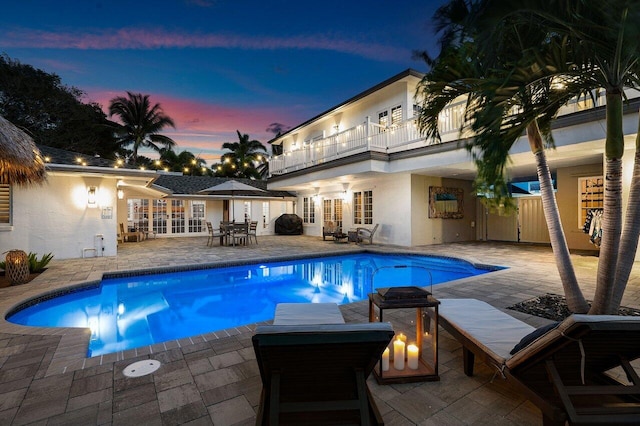 pool with a patio and french doors