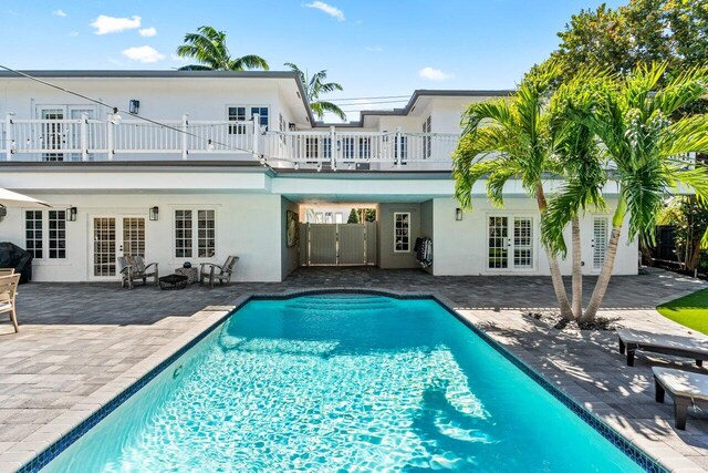 outdoor pool featuring a patio area and a yard