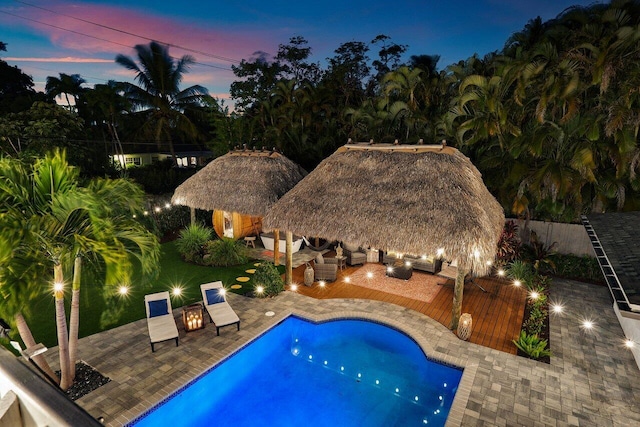 view of swimming pool with a fenced in pool, a patio, an exterior structure, fence, and an outdoor structure