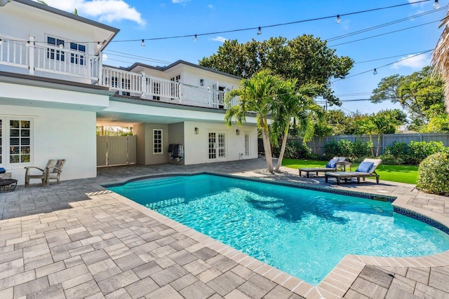 view of pool with a fenced in pool, a patio area, and fence